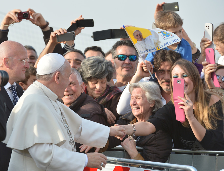 People take pictures with their mobile phones as Pope Francis arrives to visit the Roman parish of "Santa Maria dell'Orazione" in Guidonia Montecelio near Rome on March 16, 2014.  AFP PHOTO / ALBERTO PIZZOLI        (Photo credit should read ALBERTO PIZZOLI/AFP/Getty Images)